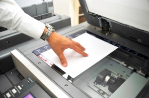 mans_hand_copying_piece_of_paper