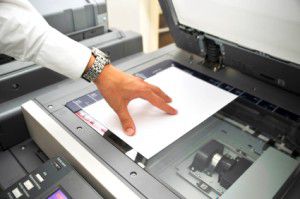 mans_hand_copying_piece_of_paper