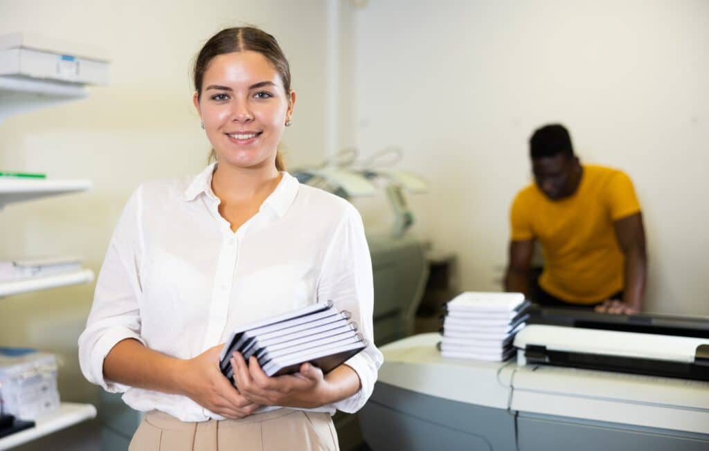 Portrait of female holding printing samples
